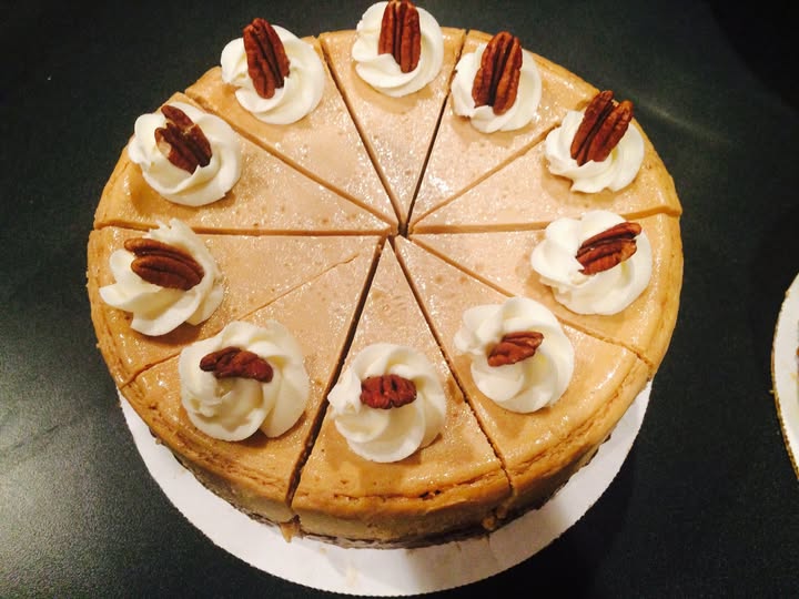 Pecan-topped cheesecake with whipped cream